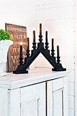 Black painted electric candlestick holder and sign with message