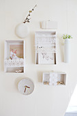 Small white wall shelves with lace border and wall clock