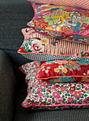 Cushions with various floral fabrics and piping