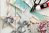 Handmade nostalgic star ornaments made out of paper, ribbons, and beads