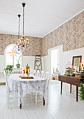 Dining table with lace tablecloth in a restored mission style room