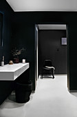 A washbasin in a black-and-white bathroom