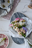 Bouquet of flowers in tissue paper on decorative marble board