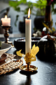 Candle decorated with autumn leaves
