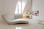 Modern curved lounger in a living room all in white