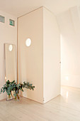 Room within a room with a porthole under the sloping ceiling