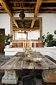 An old wooden door on capitals as a coffee table in a Mediterranean living room