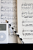 Black and white striped pencil in front of sheet music