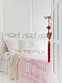 Open coffered door to bedroom with romantic bed