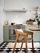 Classic eat-in kitchen with painted floorboard with a checkerboard pattern