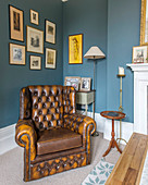 Chesterfield armchair in classic living room decorated in blue