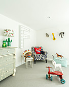 Chest of drawers, animal figurines and Native American headdress in child's bedroom