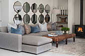 Two rows of Baroque mirrors above sofa