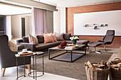 Grey sofa set in living room with brick wall