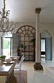 Antique pillar and arched windows in Mediterranean dining room