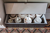 Crockery stacked in old trunk