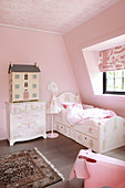 Classic girl's bedroom in attic decorated entirely in pink