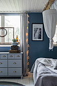 Chest of drawers in bedroom decorated in shades of blue and grey