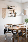 Fur blankets on designer chairs at table in Boho-style dining room