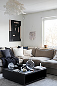 Black coffee table in front of beige sofa in living room