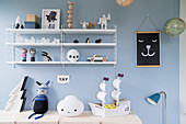 String shelves on pale blue wall of boy's bedroom