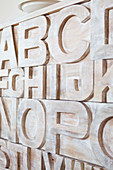Detail of carved letters on wooden cabinet