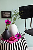 Anemone in vase on black-and-white striped side table