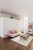 Pale pink sofa against custom loft bed in period apartment