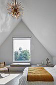 Simple attic bedroom with window seat