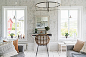 Rattan chair at desk in Scandi-style living room