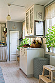 Dresser in country-house kitchen with pantry door in background