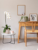 Orchid on side table next to console table and chair