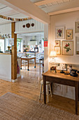 View from pleasant hall into open-plan, country-house-style kitchen