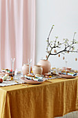 Easter table set in feminine style in shades of ochre and pink