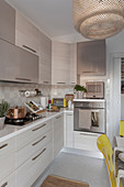 Cane lampshade in modernised kitchen in shades of beige