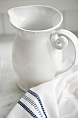 White jug and cloth on marble surface