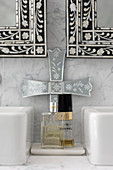 Mirrors inlaid with mother-of-pearl above perfume bottles on marble washstand