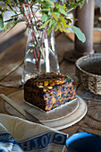 Piece of fruit cake on rustic wooden board