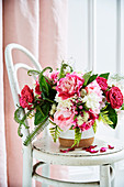 Pink and white floral bouquet with roses, peonies and fern leaves