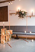 Copper wedding arch and candle lanterns in wooden crates in Industrial-style interior