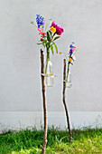 Flowers in DIY vases in garden