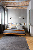 Bed in bedroom in shades of grey with vaulted ceiling