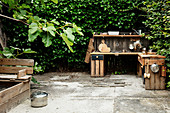 DIY outdoor play kitchen made from reclaimed wood on terrace