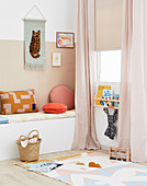 Upholstered bench in the children's room in nude and pastel shades
