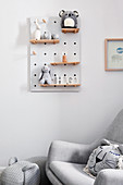 Baby toys in shades of grey on shelves on peg board