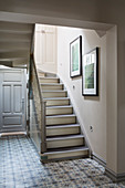 Patterned floor and staircase in classic foyer of period building