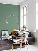Scandinavian-style living room with green wall in period building