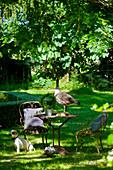 Ornate metal garden furniture in romantic seating area in garden