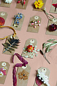 Paper gift tags decorated with dried flowers and leaves