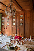 Festively set table in wood-panelled dining room